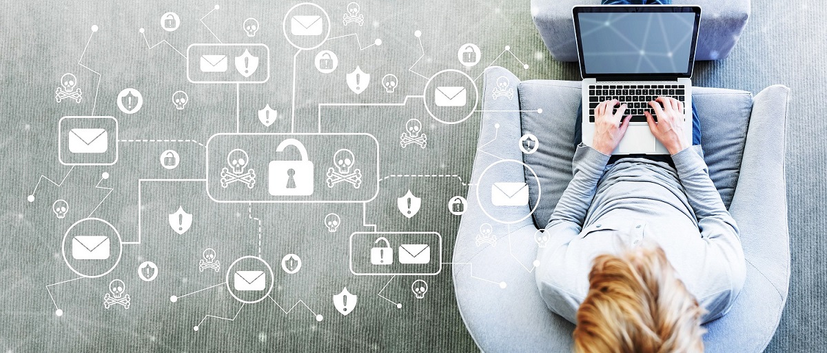 Email Virus and Scam theme with man using a laptop in a modern gray chair